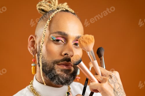 Preview: Latino gay make up artist holding makeup brush