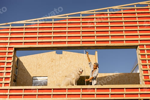 Preview: Man with his dog on construction site