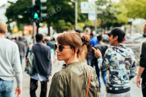 Preview: Woman walking on crowded city street