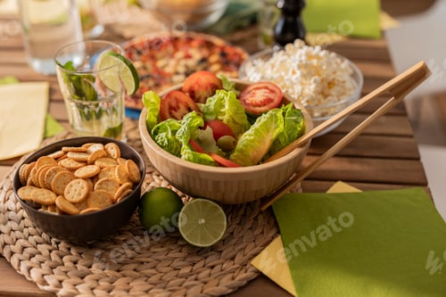 Preview: wooden table with various food salad cookies pizza lemon