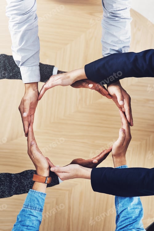 Preview: High angle shot of a group of unidentifiable businesspeople forming a circle with their hands