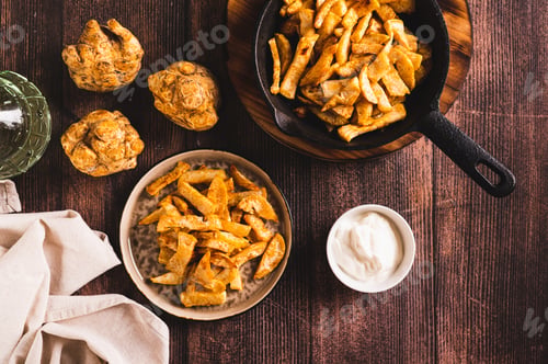 Preview: Pieces of celery root fried with paprika on a plate on the table top view