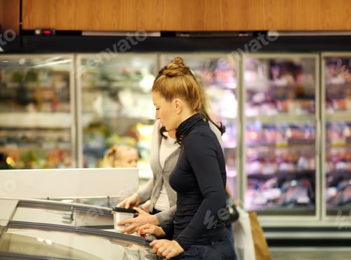 Preview: Women Choosing Frozen Food From A Supermarket Freezer