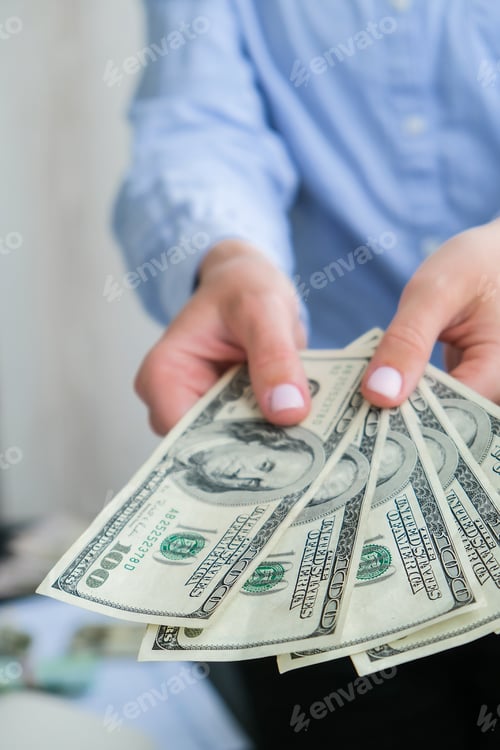 Preview: Business Woman Displaying a Spread of Cash US dollars. Close-up. Income and Business concept. Venali