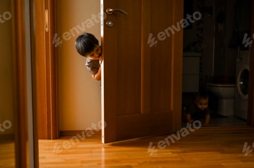 Preview: Two little boys play hide-and-seek at home