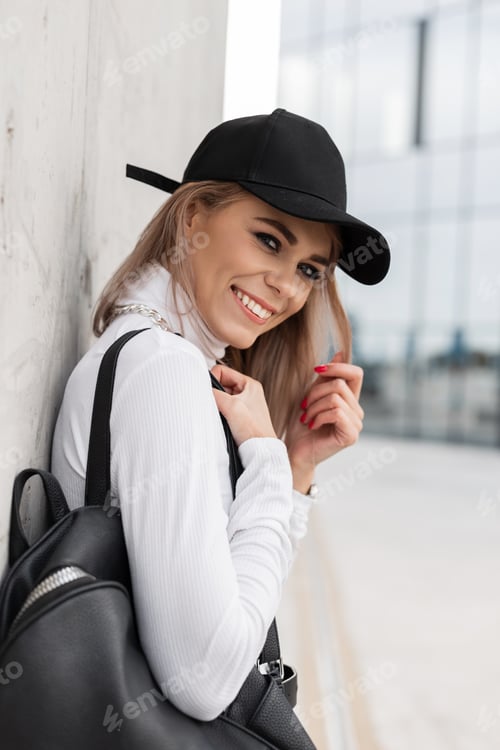 Preview: Fashion beautiful happy woman in stylish casual clothes on urban background