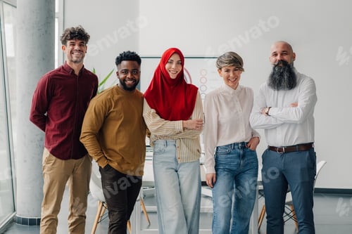 Preview: Startup business team posing together in modern office