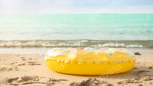 Preview: Swimming Ring on Sand Beach with Blue Sky Background