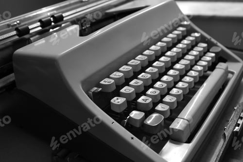 Preview: Grayscale closeup shot of details on a vintage typewriter