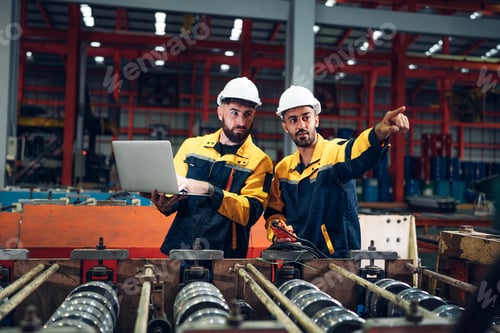 Preview: Industrial man engineer using laptop are checking system machine at factory.