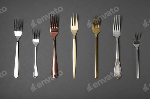 Preview: Set of different forks on black background, flat lay