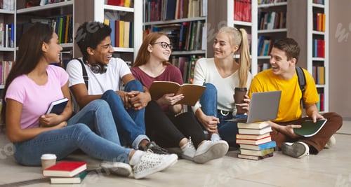 Preview: Cheerful girl telling her friends funny story, sitting at library