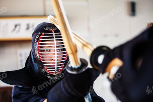 Preview: Close up of Japanese Kendo fighter wearing Kendo mask in combat pose.