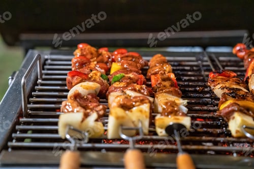 Preview: Barbeque skewers meat with vegetable grilling on charcoal bbq grill in backyard
