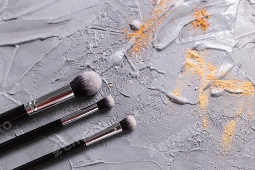 Preview: Mineral powder for face and a brushes for powder and visage on grey background. Eco friendly and