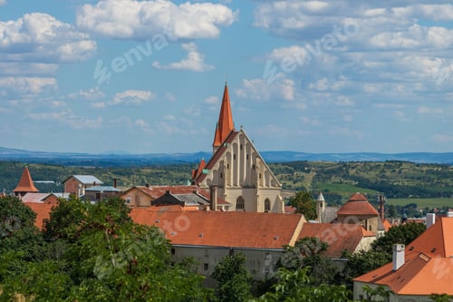 Preview: Historic European town with red-roofed buildings and church.