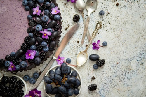 Preview: Sweet and tasty tart with fresh blueberries, blackberries and grapes, served on stone background