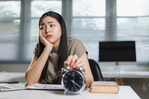 Preview: Young woman feeling tired and turning off alarm clock