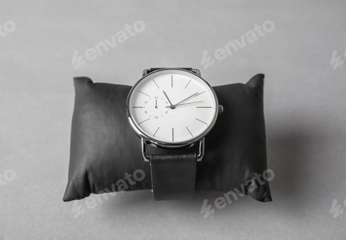 Preview: Small decorative pillow with stylish wrist watch on gray background. Fashion accessory