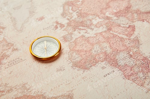 Preview: golden compass on vintage world map