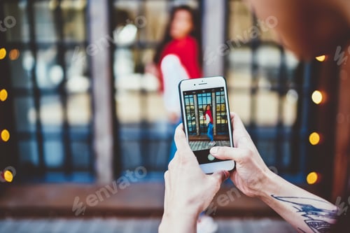 Preview: Man taking picture of girlfriend in street