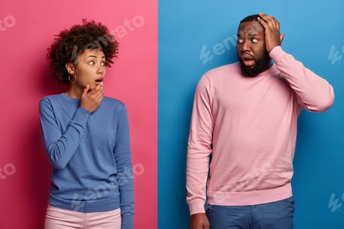 Preview: Stupefied Afro couple stare at each other with embarrassement, have trouble, think together how to s