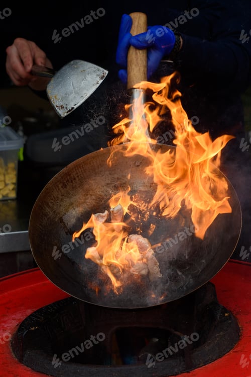 Preview: A chef prepares Chinese food at a street food festival.