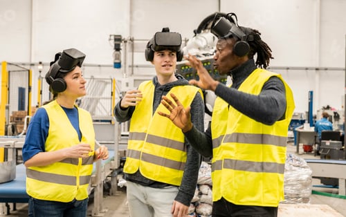 Preview: multiracial engineers in factory in simulation with virtual reality glasses - metaverse concept -