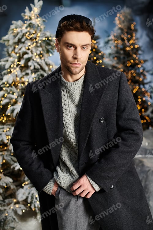 Preview: A handsome man in warm winter clothes stands among snow-covered pines for a celebration