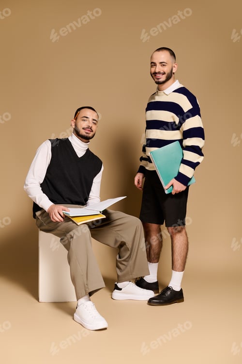 Preview: Stylish twins posing confidently in modern attire with notebooks on a warm backdrop