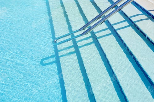 Preview: Background of water in blue swimming pool, water surface with a sun reflection