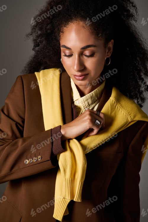 Preview: Stylish African American woman showcasing autumn fashion in a studio setting