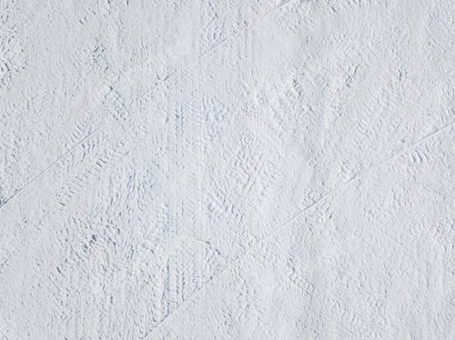 Preview: Aerial view of Snow covered winter landscape with traces of car tires sled footprints in deep snow