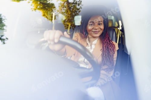 Preview: Portrait of positive african american lady inside the car