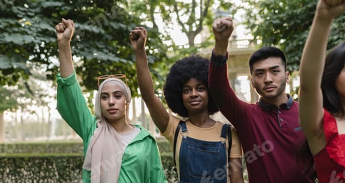 Preview: young lady leading group of young people demonstrators doing riot outdoors. Charismatic