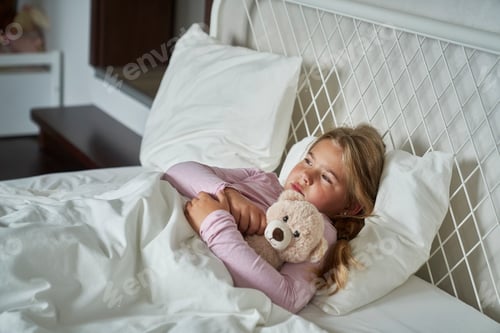 Preview: Ill elementary age girl lying in bed