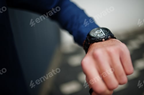 Preview: Wristwatch on Person Wearing Blue Shirt
