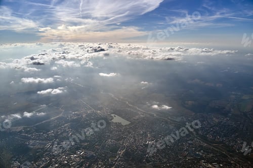 Preview: Aerial view from airplane window at high altitude of distant city
