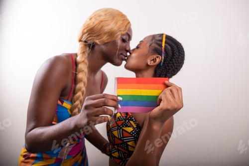 Preview: two african lesbian girls kiss and hold rainbow flag, same sex girlfriends.