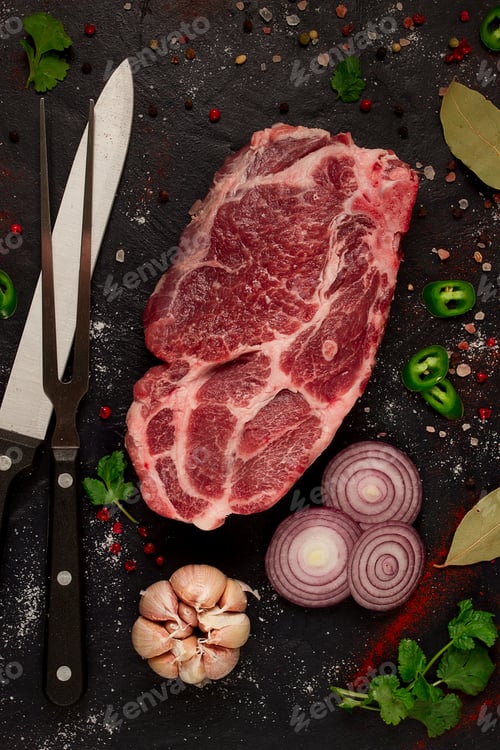Preview: pork neck, raw tenderloin, with spices, on the table, top view, no people, black background,