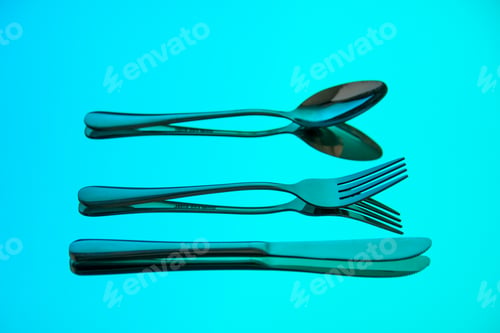 Preview: front view different cutlery spoon knife and fork on blue background table food photo metal bright