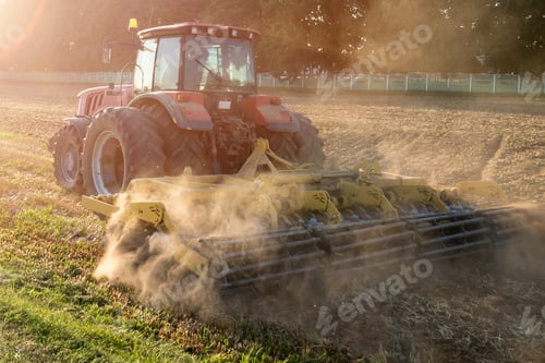 Preview: tractor cultivator plows the land, prepares for crops. dust on field