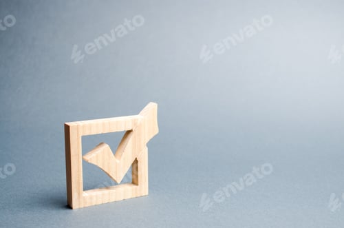 Preview: wooden checkmark for voting on elections on a gray background