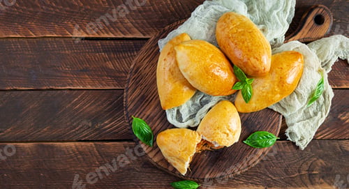 Preview: Traditional Russian cabbage pies on wooden background