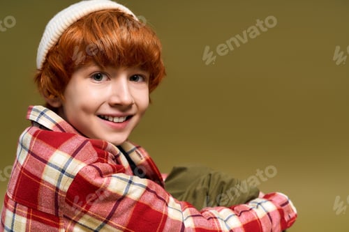 Preview: Stylish little boy with vibrant hair and trendy outfit posing with a joyful smile