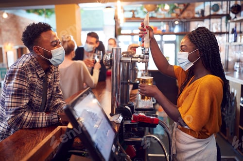 Preview: Female Bartender Wearing Face Mask Serving Male Customer With Beer During Health Pandemic