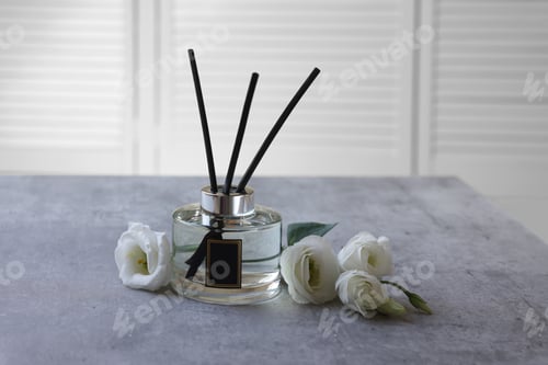 Preview: Reed diffuser and eustoma flowers on gray marble table