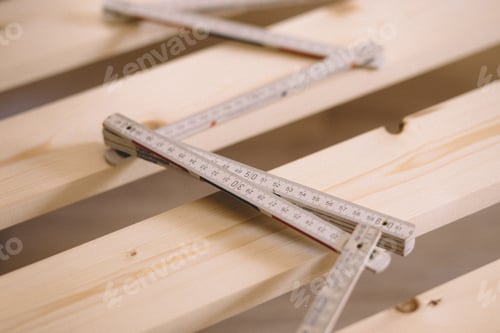 Preview: close up construction roulette on the wooden desk, self-Assembly of furniture