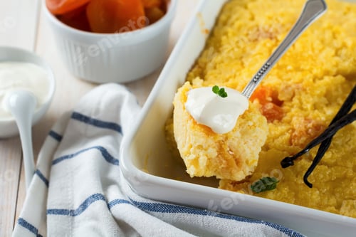 Preview: Millet pudding with dried apricots for breakfast on a light background. Selective focus