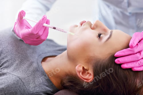 Preview: Attractive young woman gets cosmetic face injection